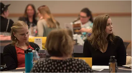 Participants seated at tables during a Northern Kentucky University event.