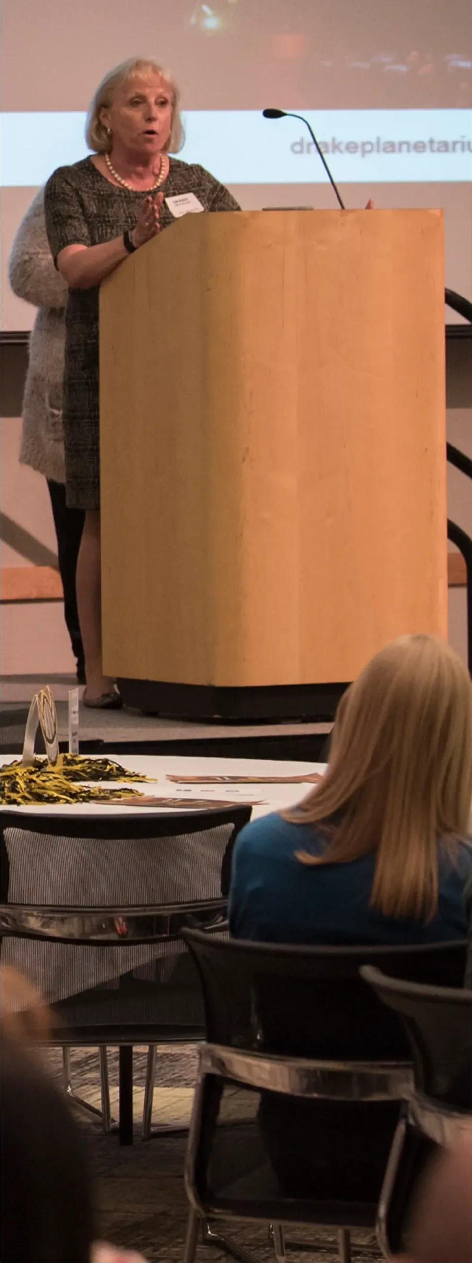 Woman speaking at a podium during a formal event at Northern Kentucky University.