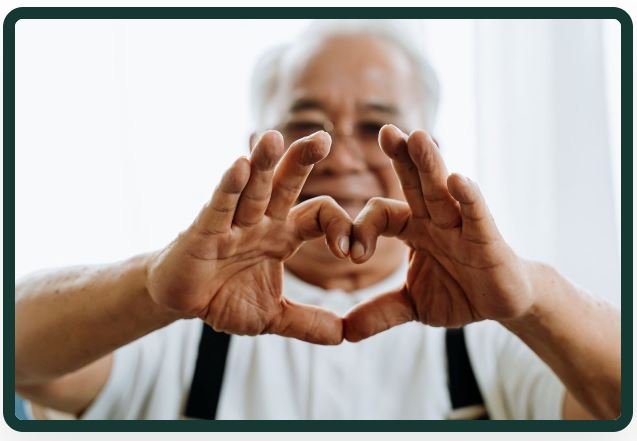 Senior with heart hands